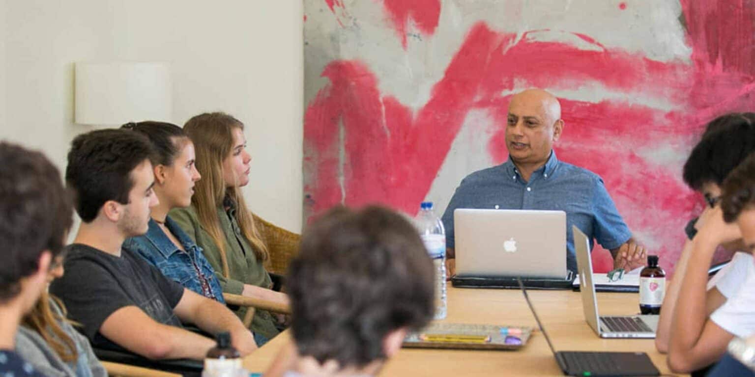 Engaging classroom scene with students and teacher at a modern international school.