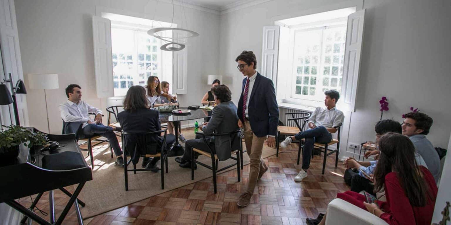 Students in a classroom discussing, displaying international education at a World Schools conference.