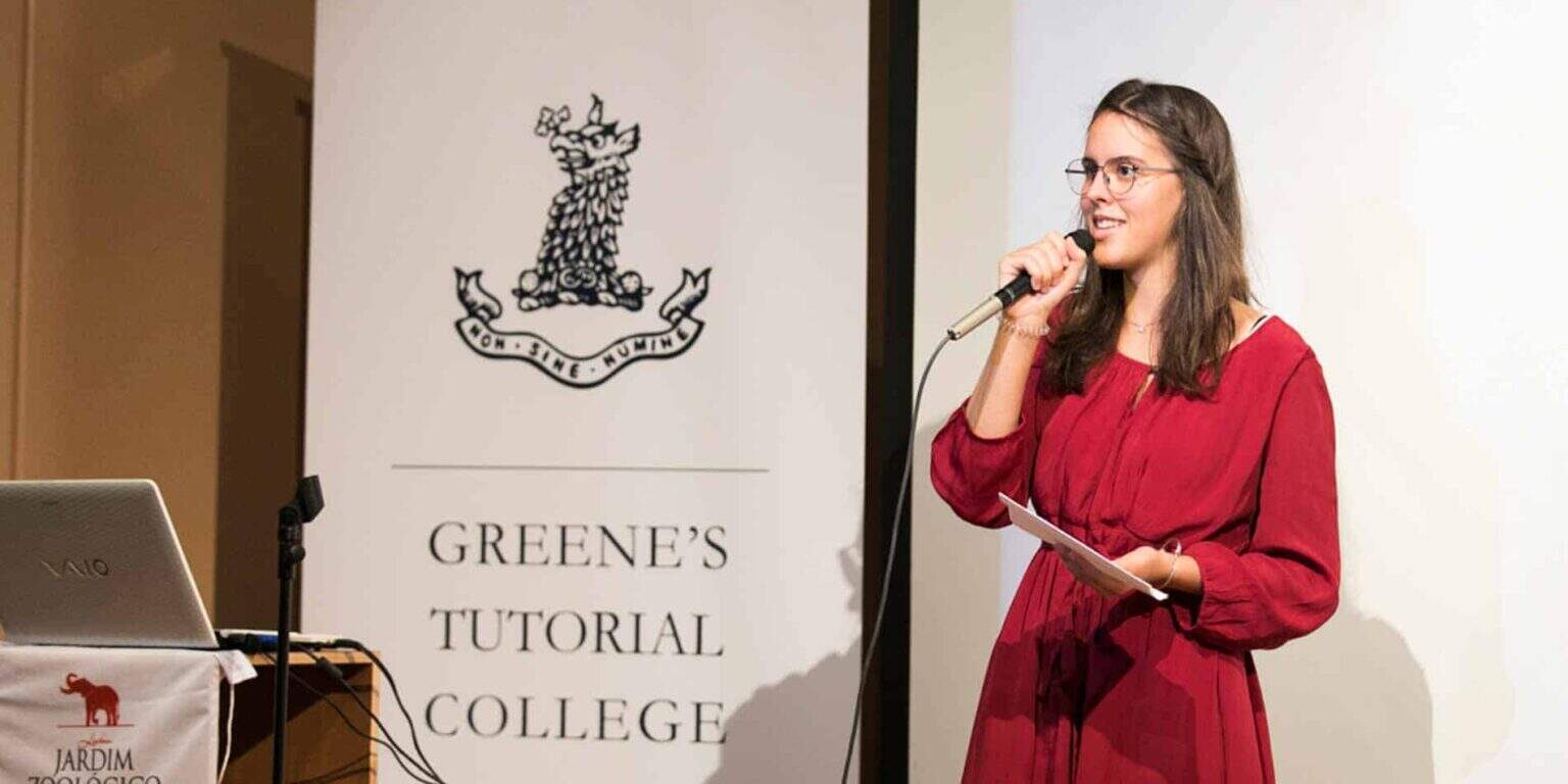 Young girl presenting at Green's Tutorial College event, emphasizing educational excellence and student engagement.