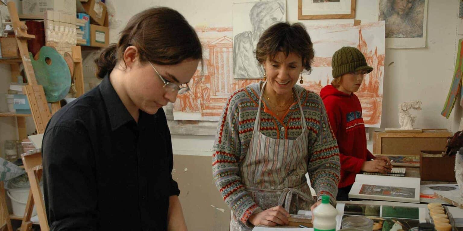 Creative art class with students and teacher in an art studio for international schools.