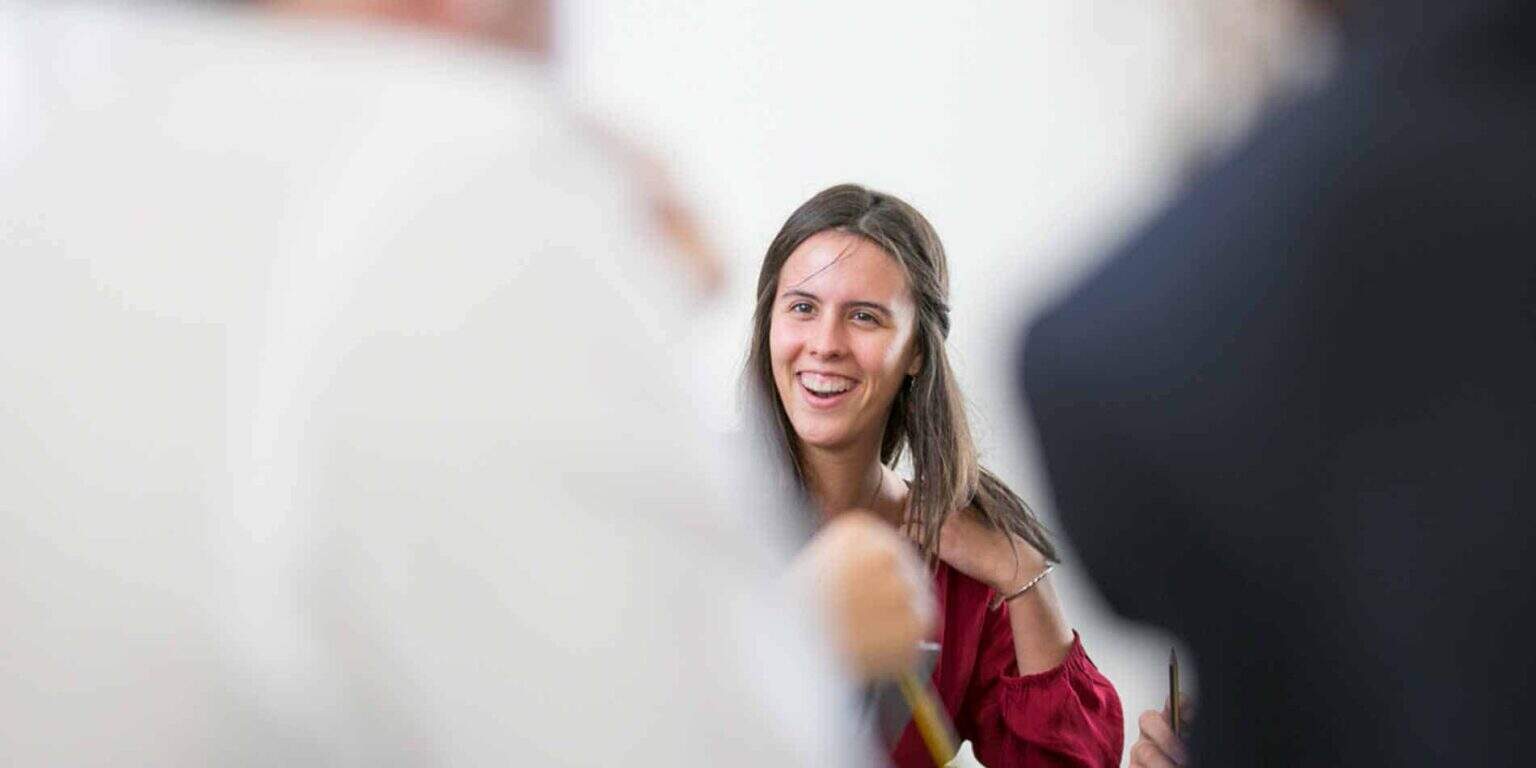 Diverse group of students engaging in a lively classroom discussion, promoting global education at World Schools.