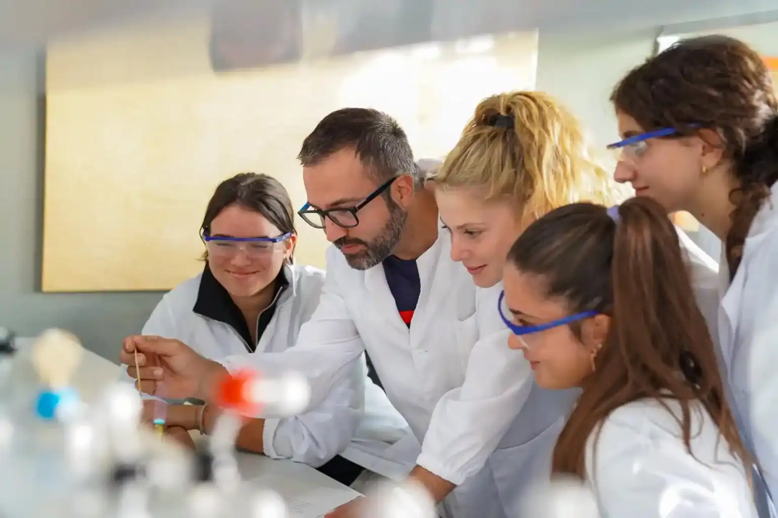 Innovative science class at World Schools with students and teacher conducting experiments.