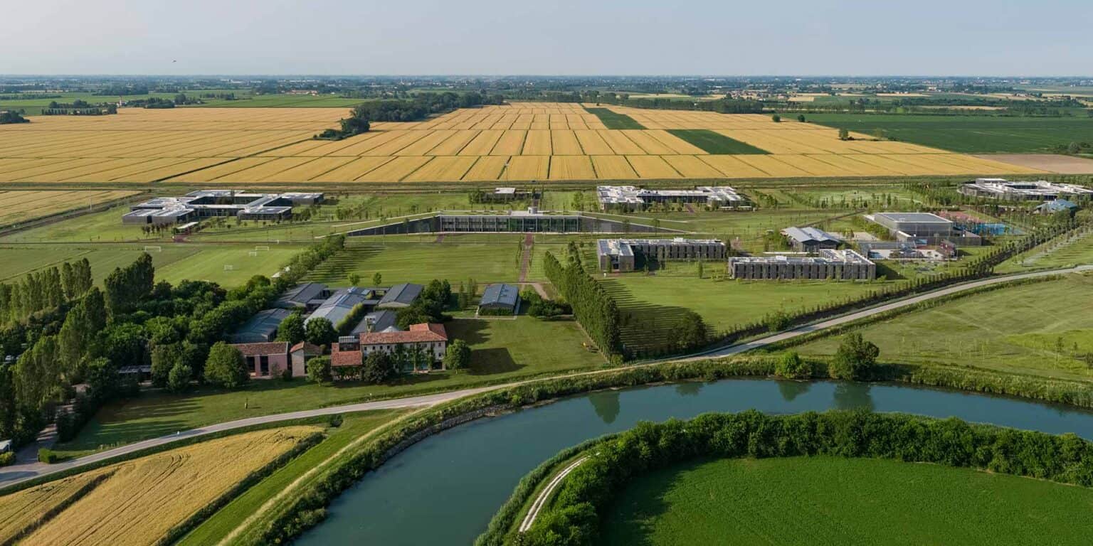 Modern international school campus with green fields and surrounding landscape, part of World Schools network.