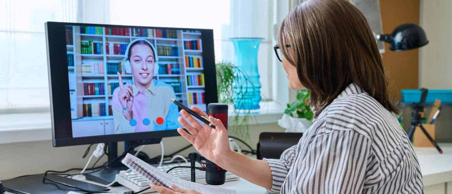 Online learning with a teacher through a computer screen at World Schools program.