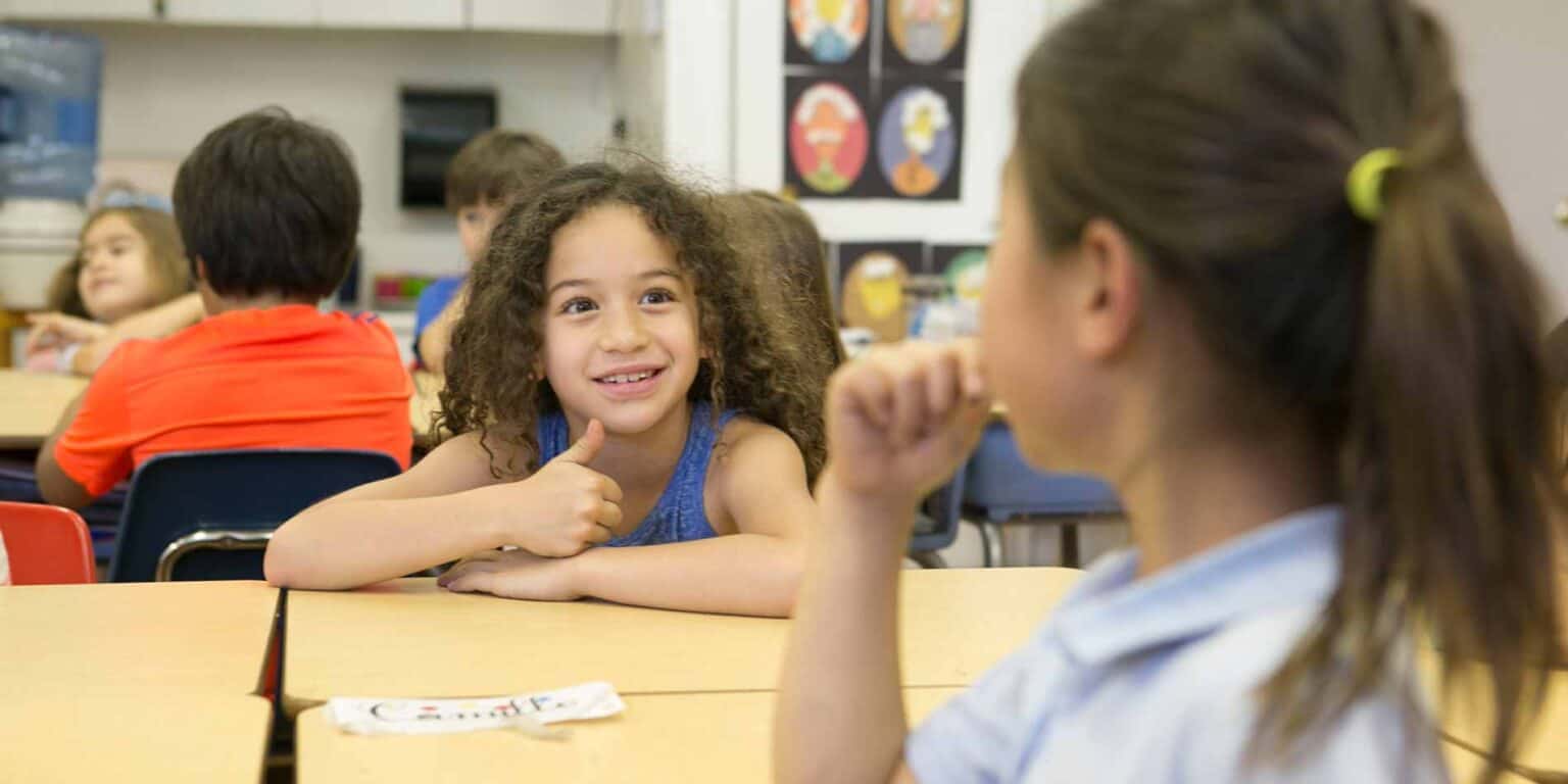 Vibrant classroom of diverse students engaging in interactive learning activities at World Schools.