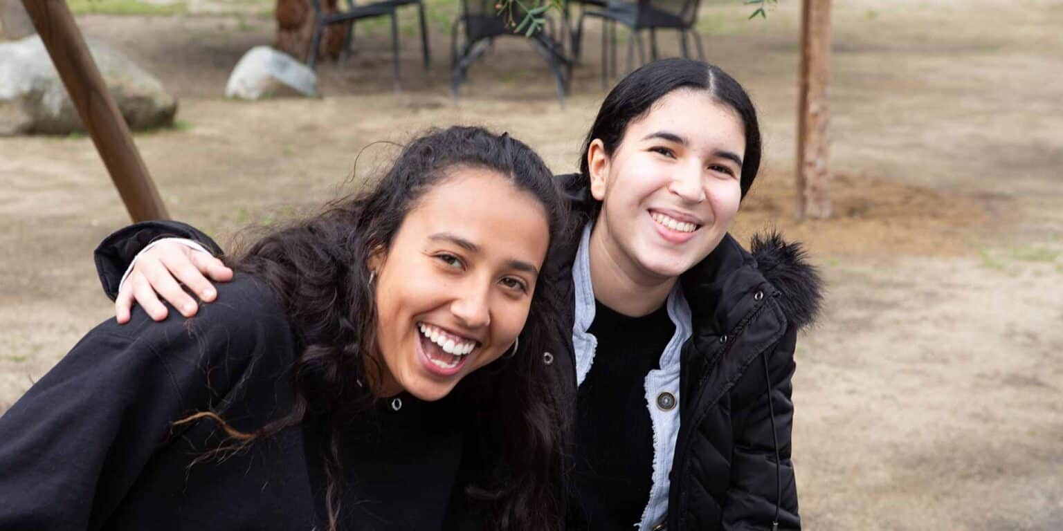 Bright students at a worldwide school, embracing diversity and learning together outdoors.