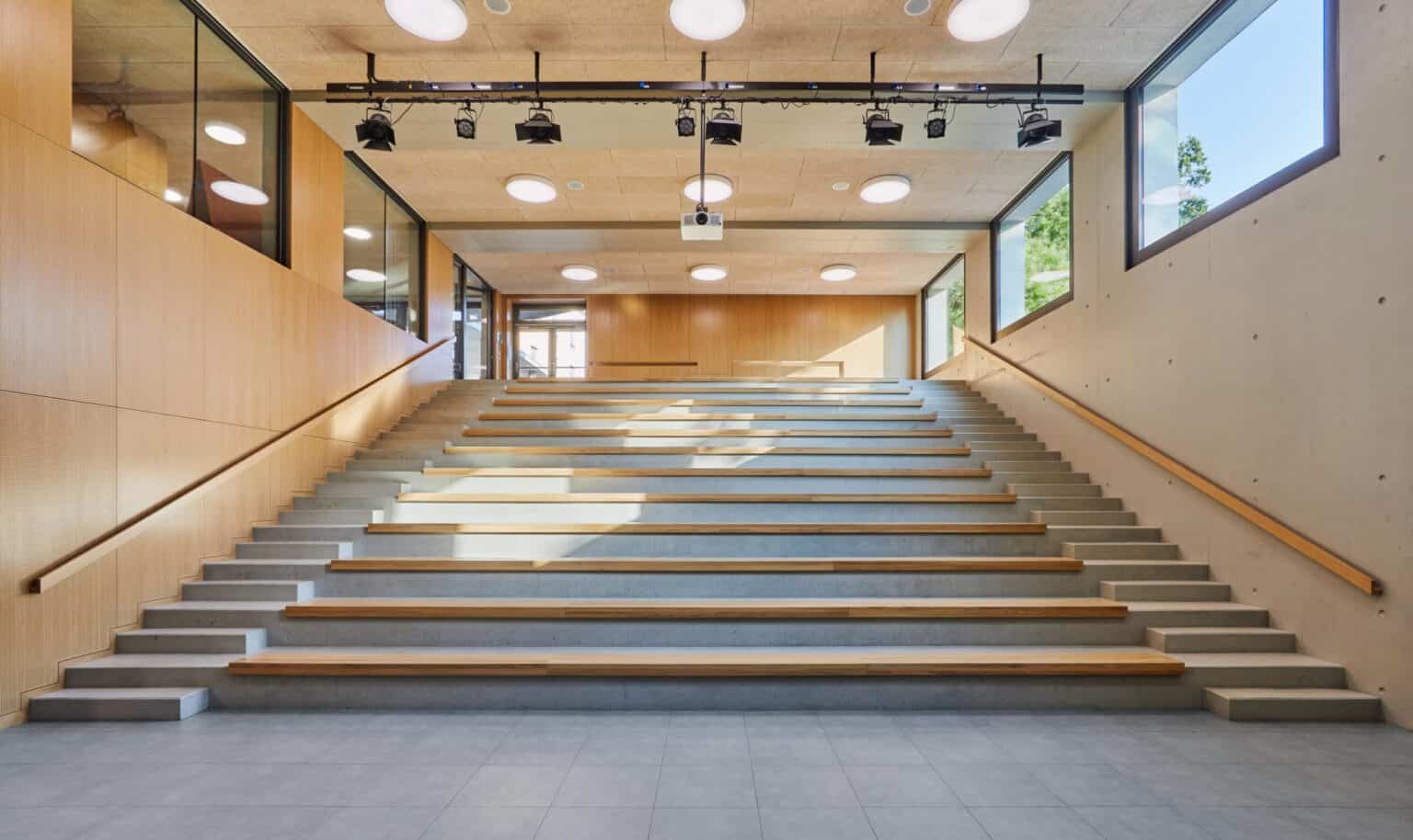 Bright modern school staircase with natural light, wooden accents, ideal for international students.