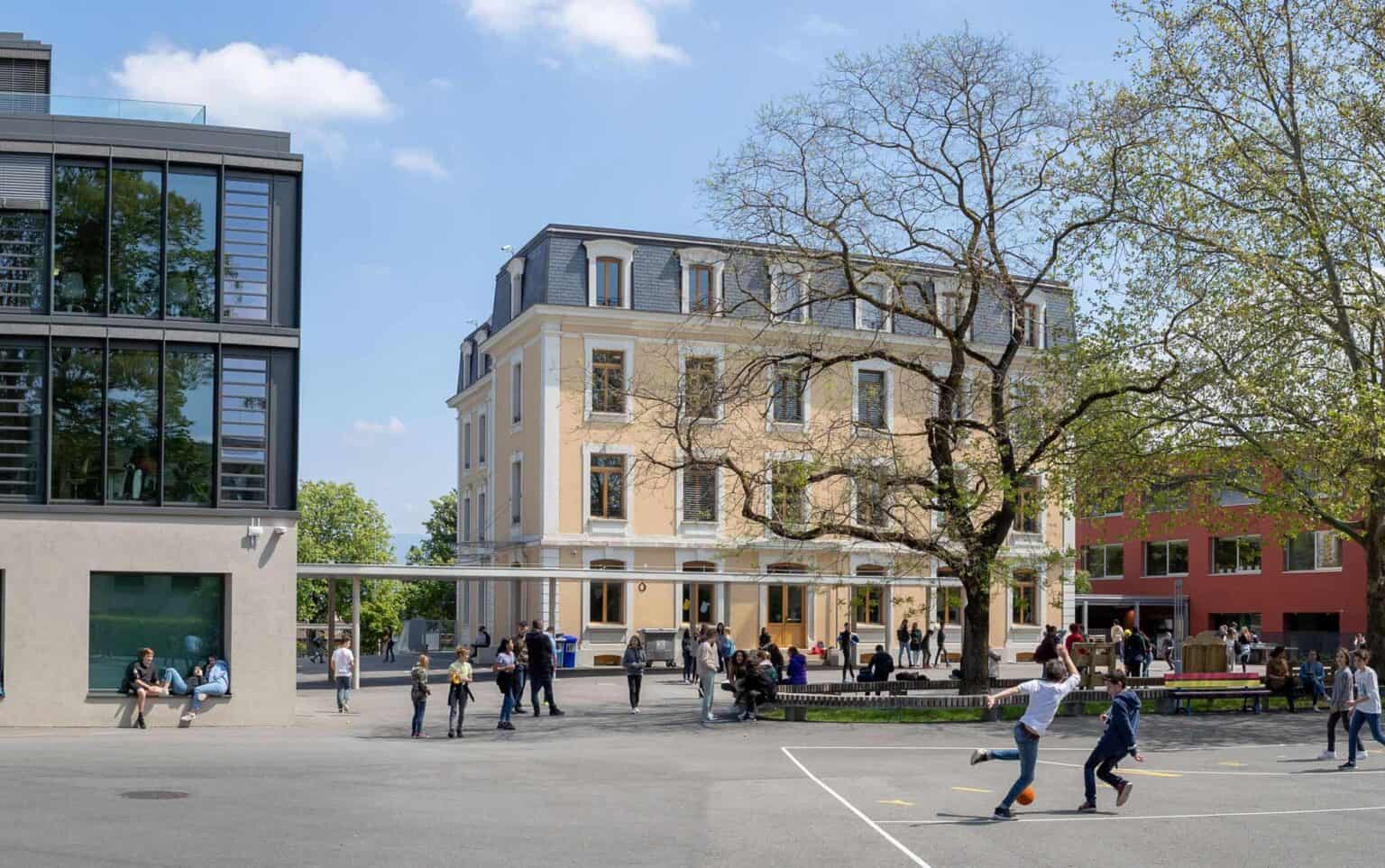 Modern urban school campus with students engaging outdoors, showcasing world-class international education.