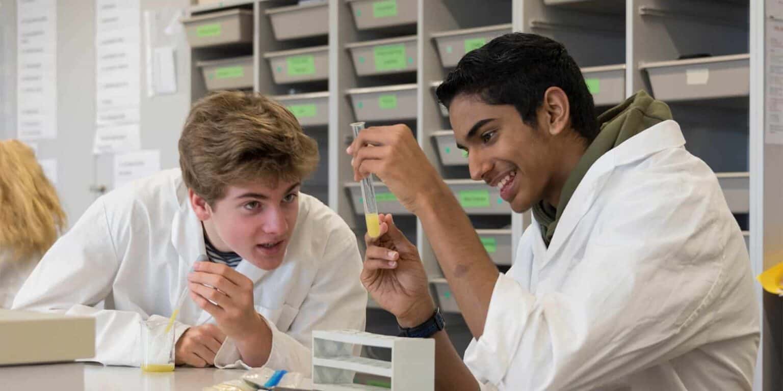 Young students conducting science experiments in a school laboratory, engaging in STEM education and learning innovative skills.