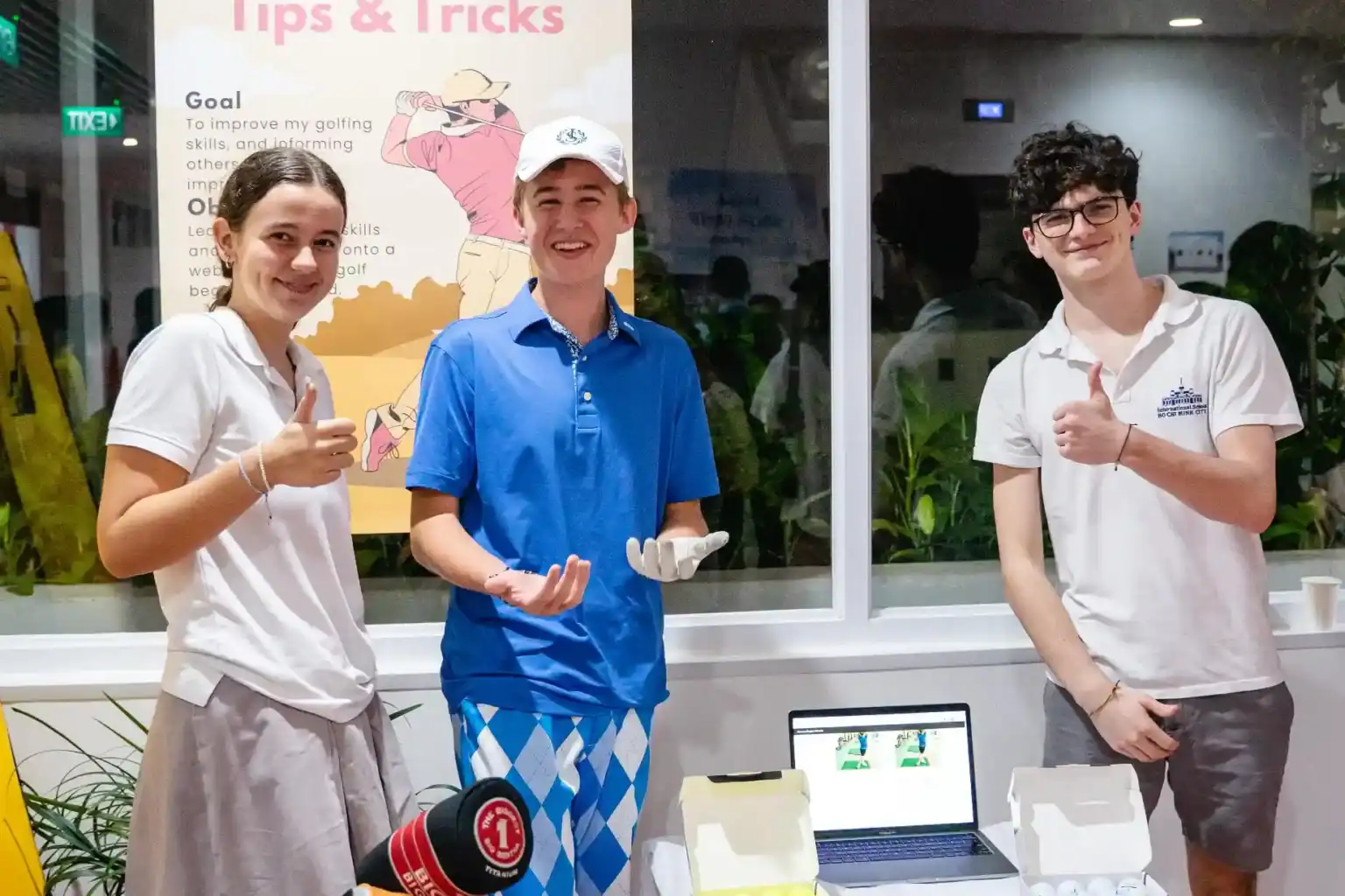 High school students presenting innovative projects at a global education event.