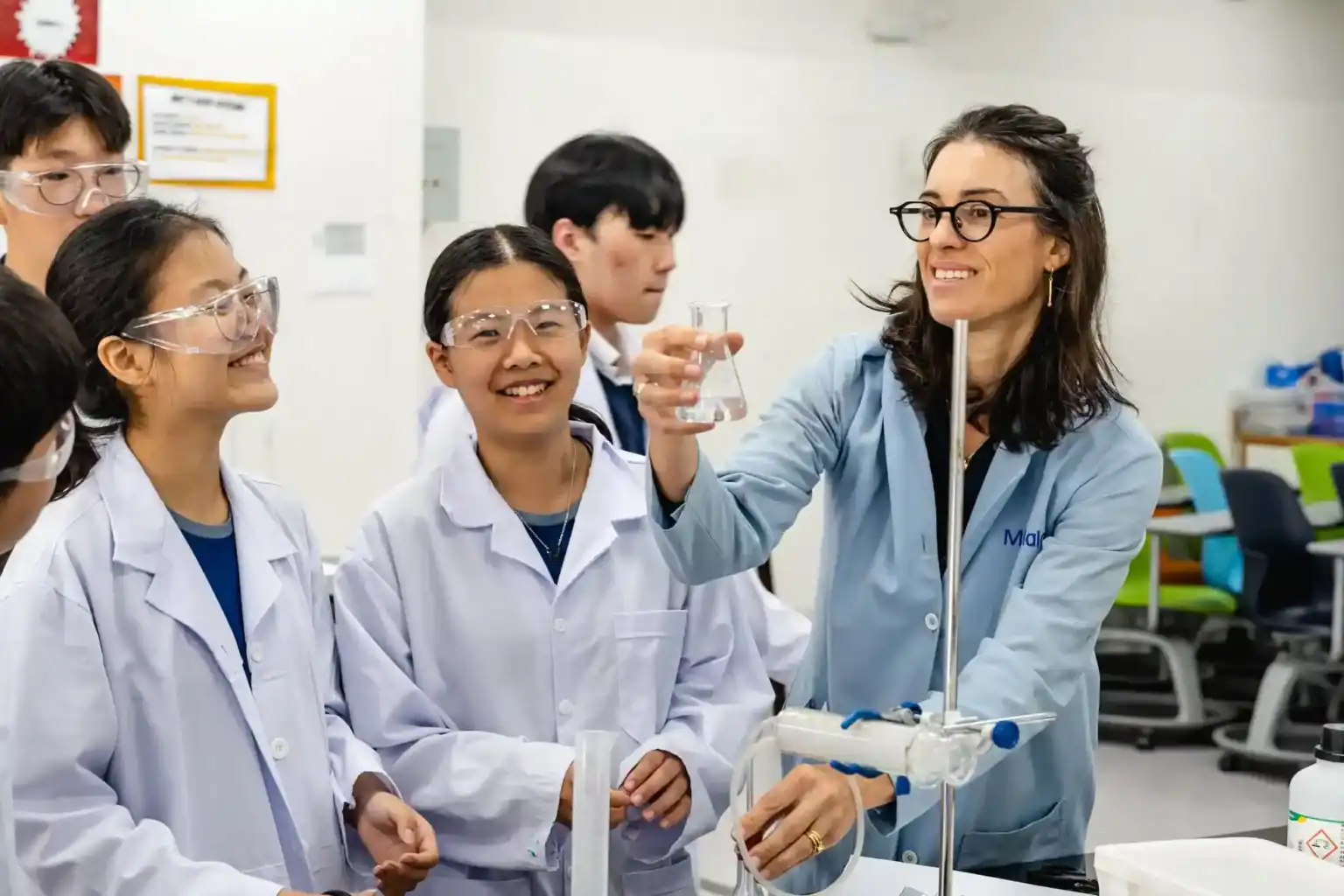 Engaged students conducting science experiments in a classroom at World Schools.
