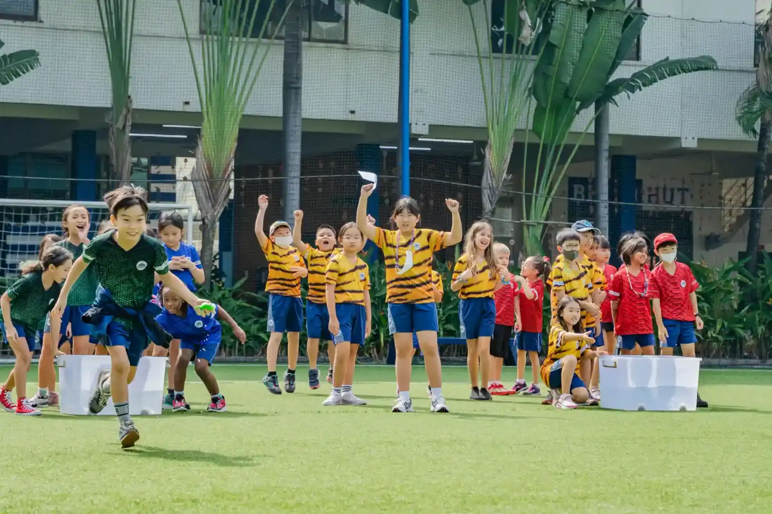 Excited students participating in outdoor sports at a prestigious world school campus.