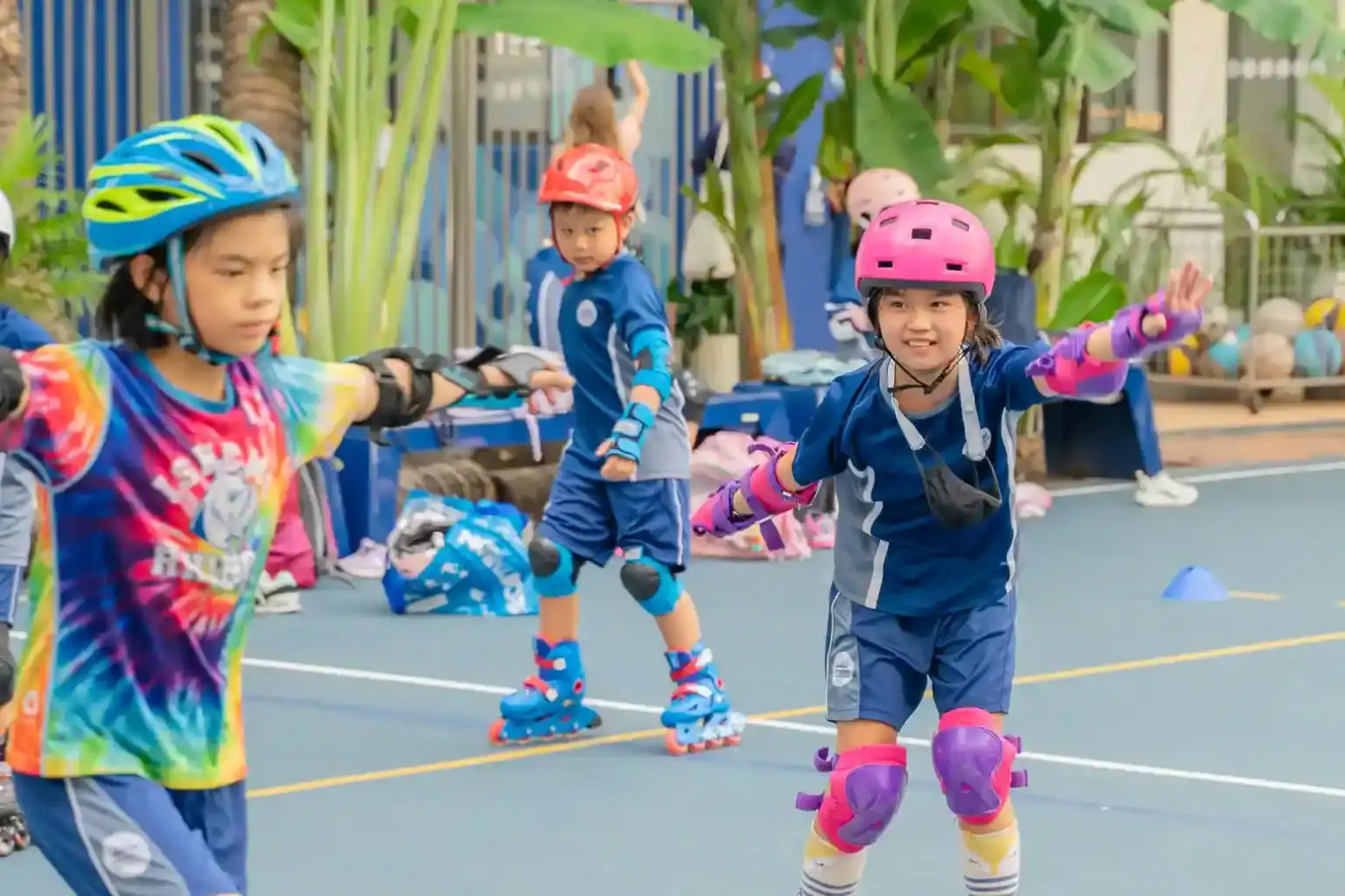 Children rollerblading outdoors at World Schools fitness activity.