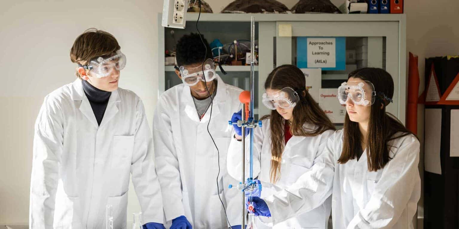 Innovative students conducting chemistry experiments in a school laboratory, promoting STEM education and scientific curiosity.