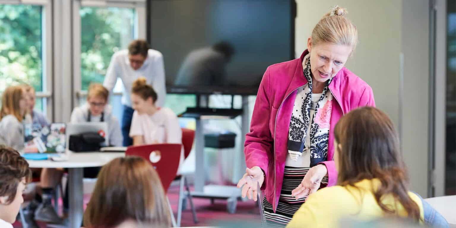 Engaging classroom with diverse students and a dedicated teacher promoting collaborative learning at World Schools.