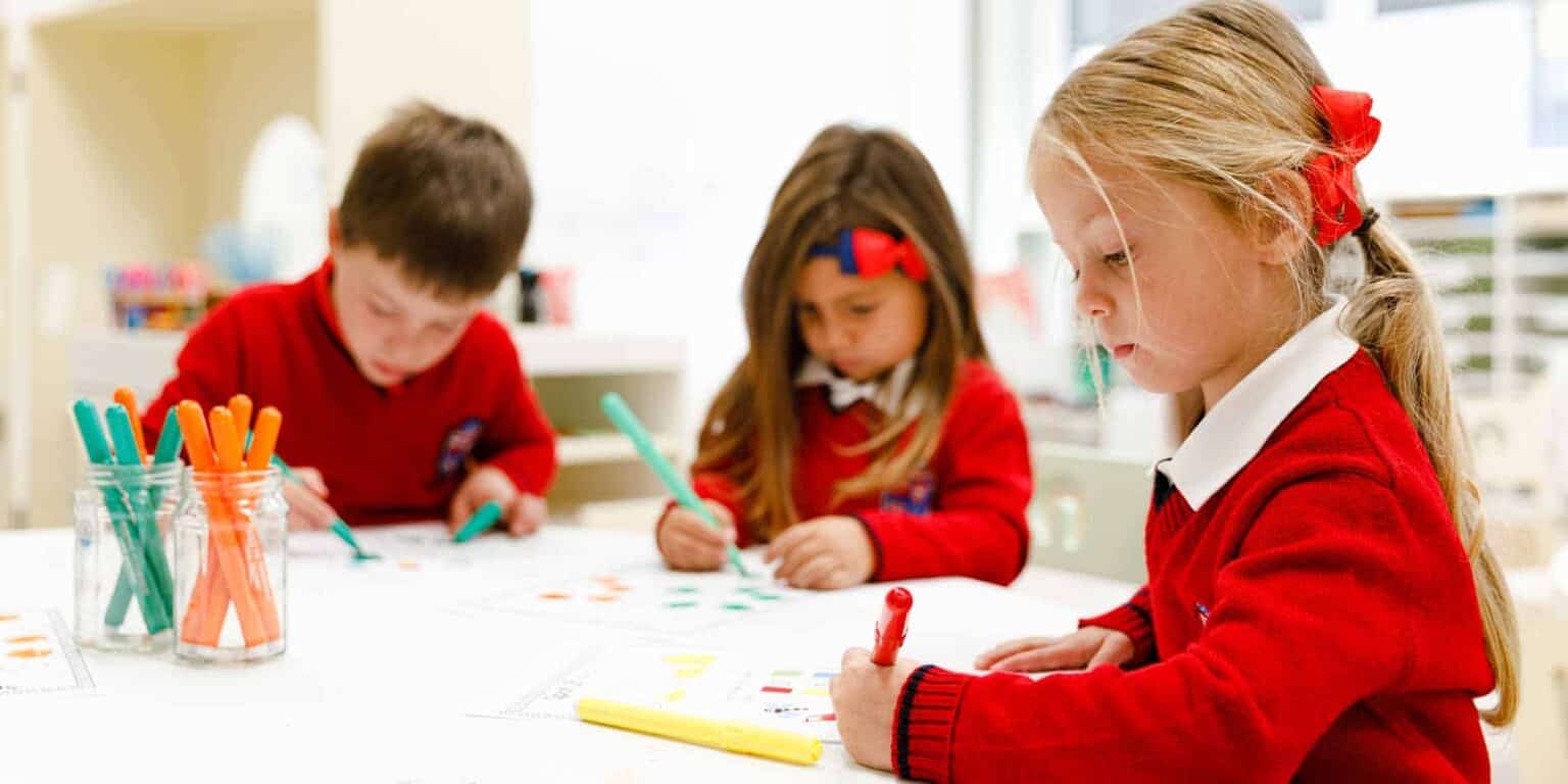 Children engaged in classroom activities at a world schools setting, fostering creativity and learning.