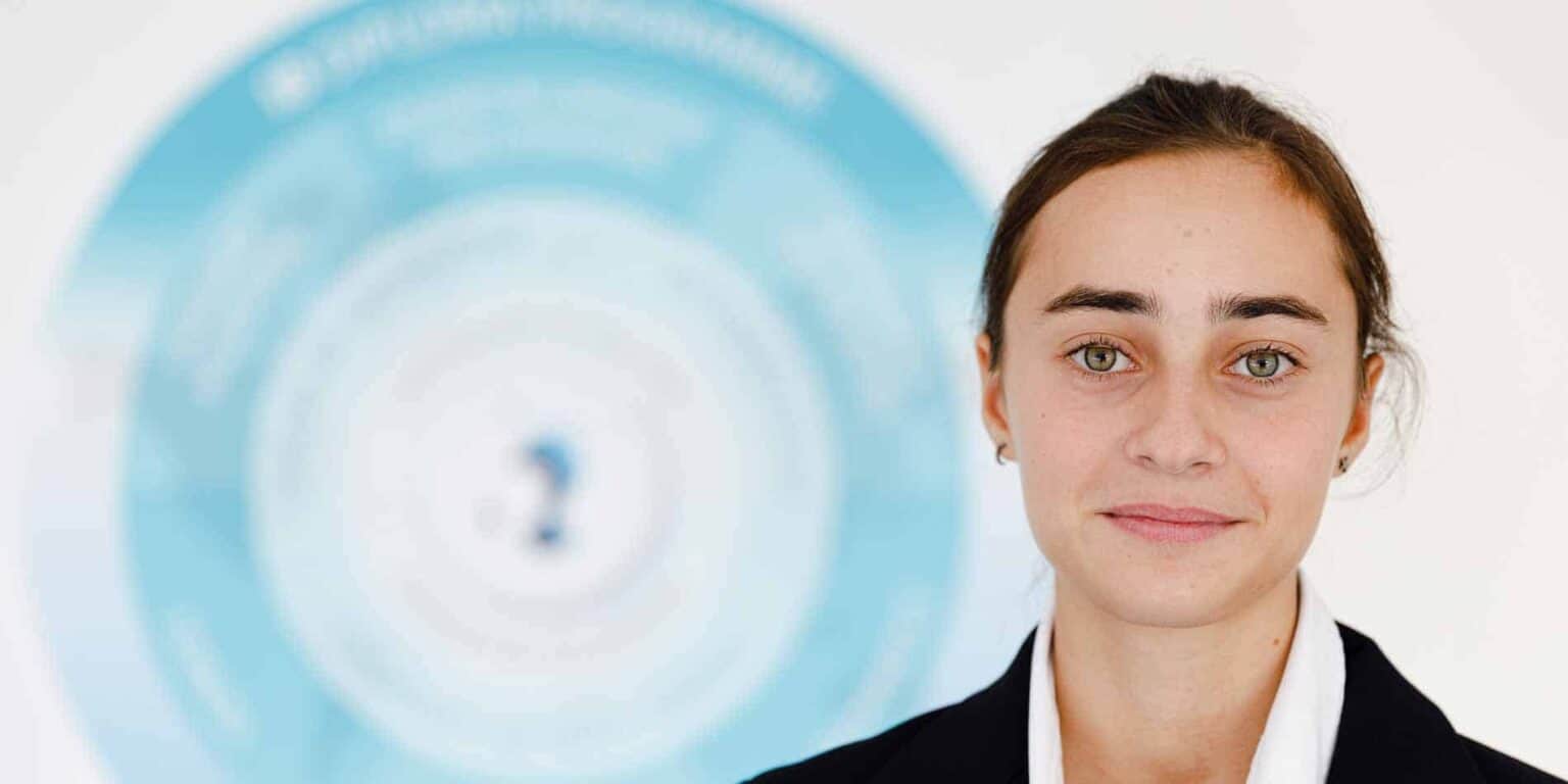 High school girl in formal attire with a question mark symbol behind her, representing education and inquiry.