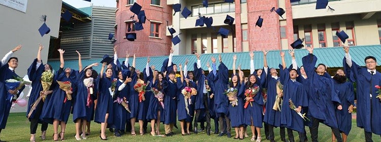 Graduates celebrating success at a prestigious international school graduation ceremony.