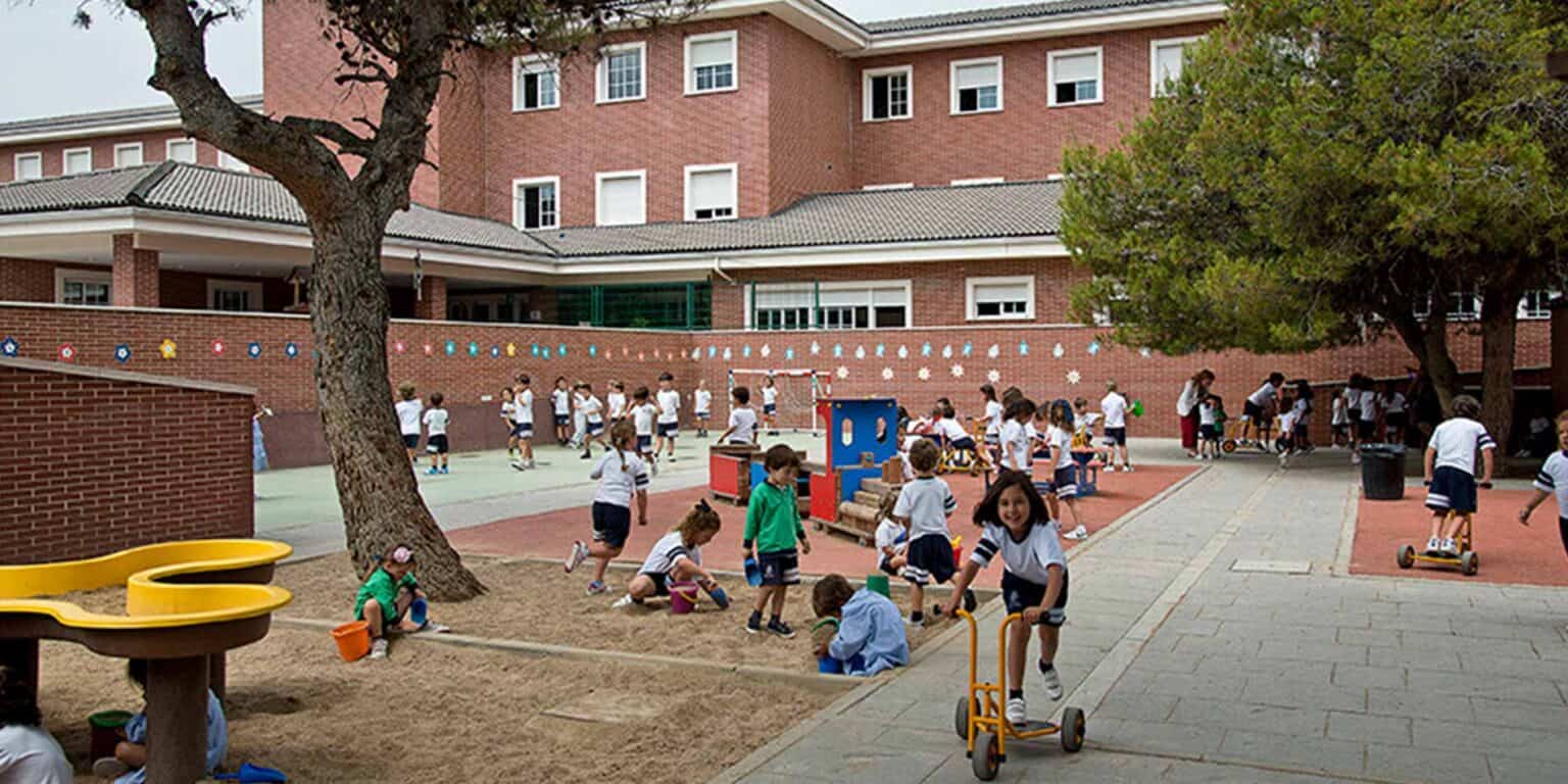 Bright school playground with children playing and learning outdoors at a prestigious international school.