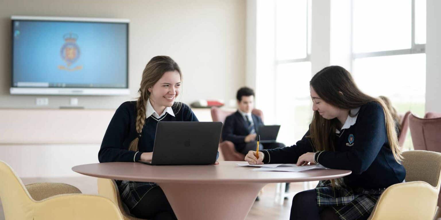 Smiling students working together in a modern classroom, showcasing international education at World Schools.