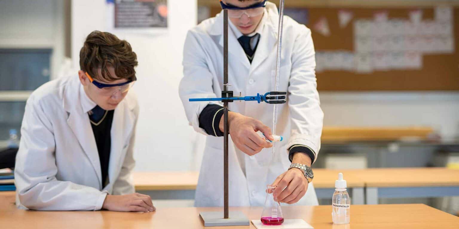 Innovative students conducting chemistry experiments in a science classroom at a world school.