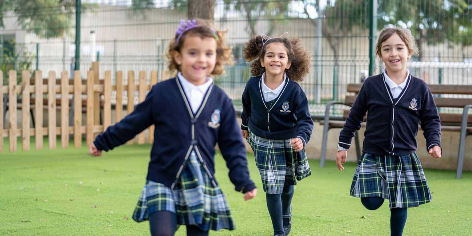 Bright young students enjoying outdoor activities at World Schools campus, promoting holistic education.