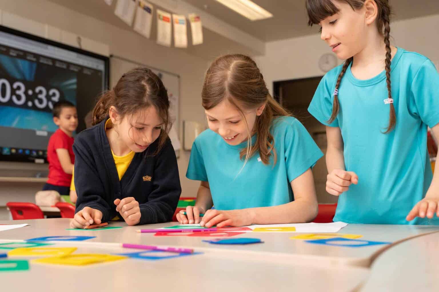 Happy students collaborating in a classroom at a top international school.
