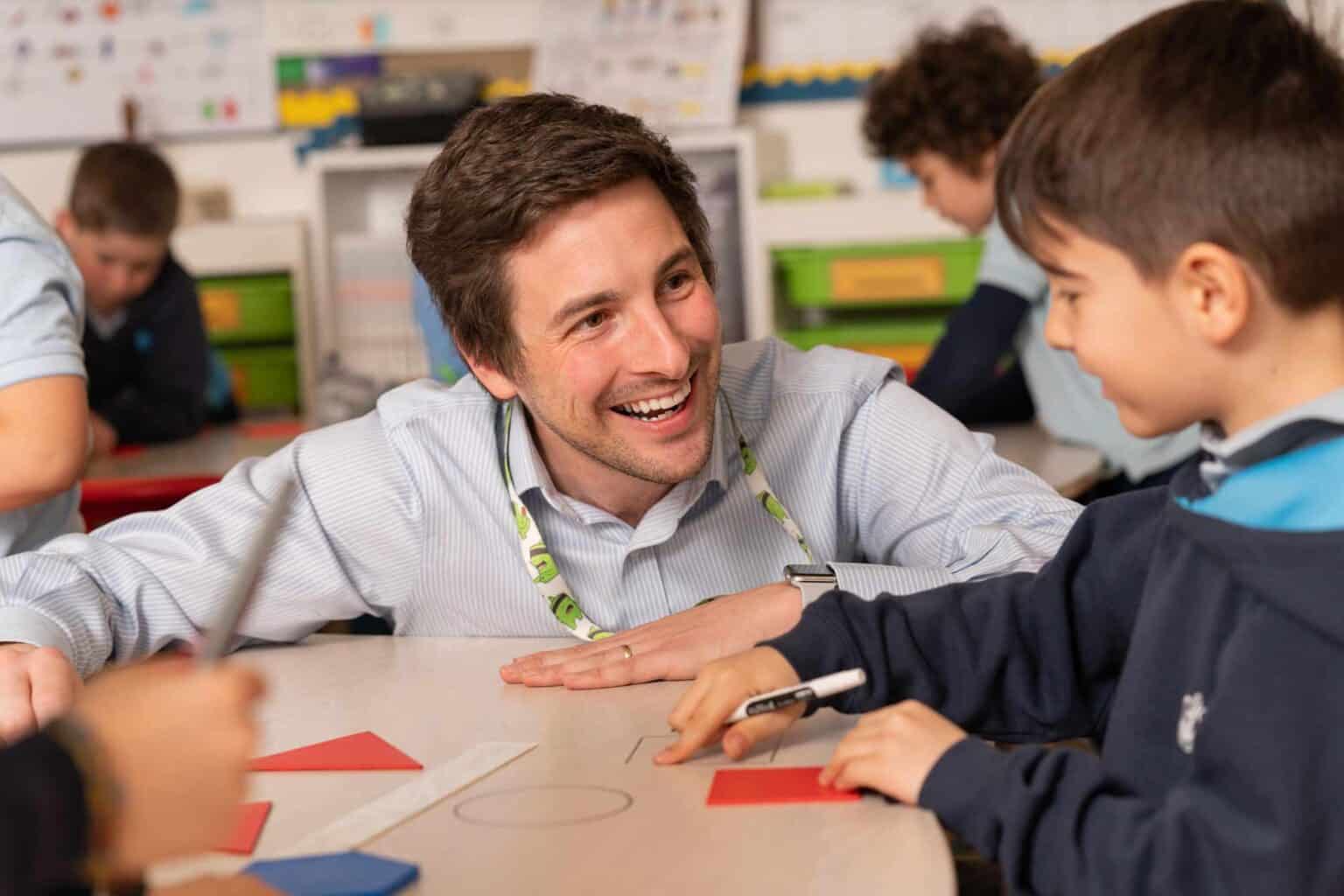 Engaging teacher interacting with students in a vibrant classroom setting focusing on global education.