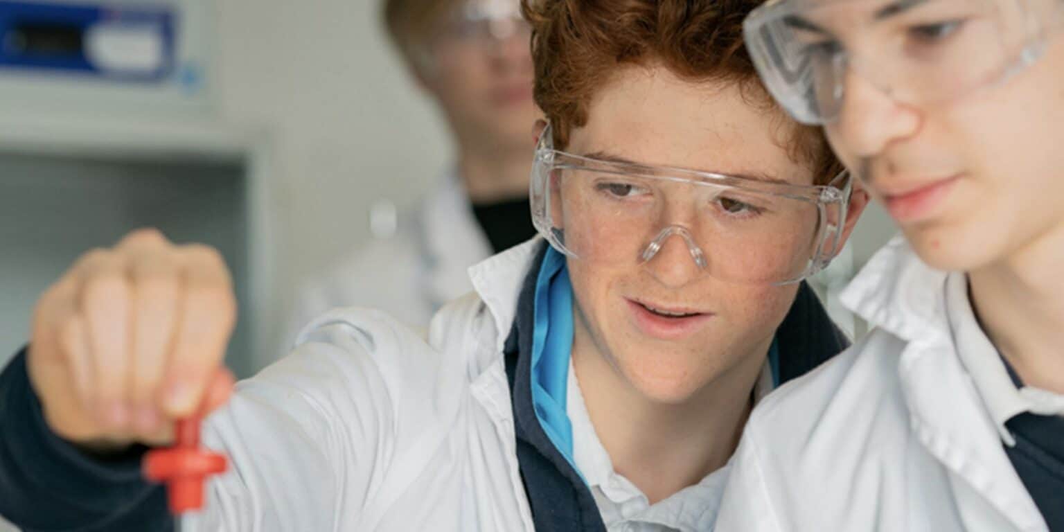 Young students conducting science experiments in a classroom at a world school focused on educational excellence and global learning.