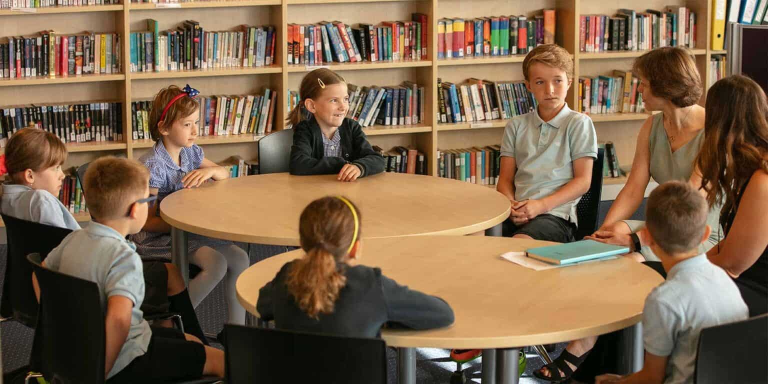 Students participating in a classroom discussion at a world school, fostering international education and diverse learning environments.