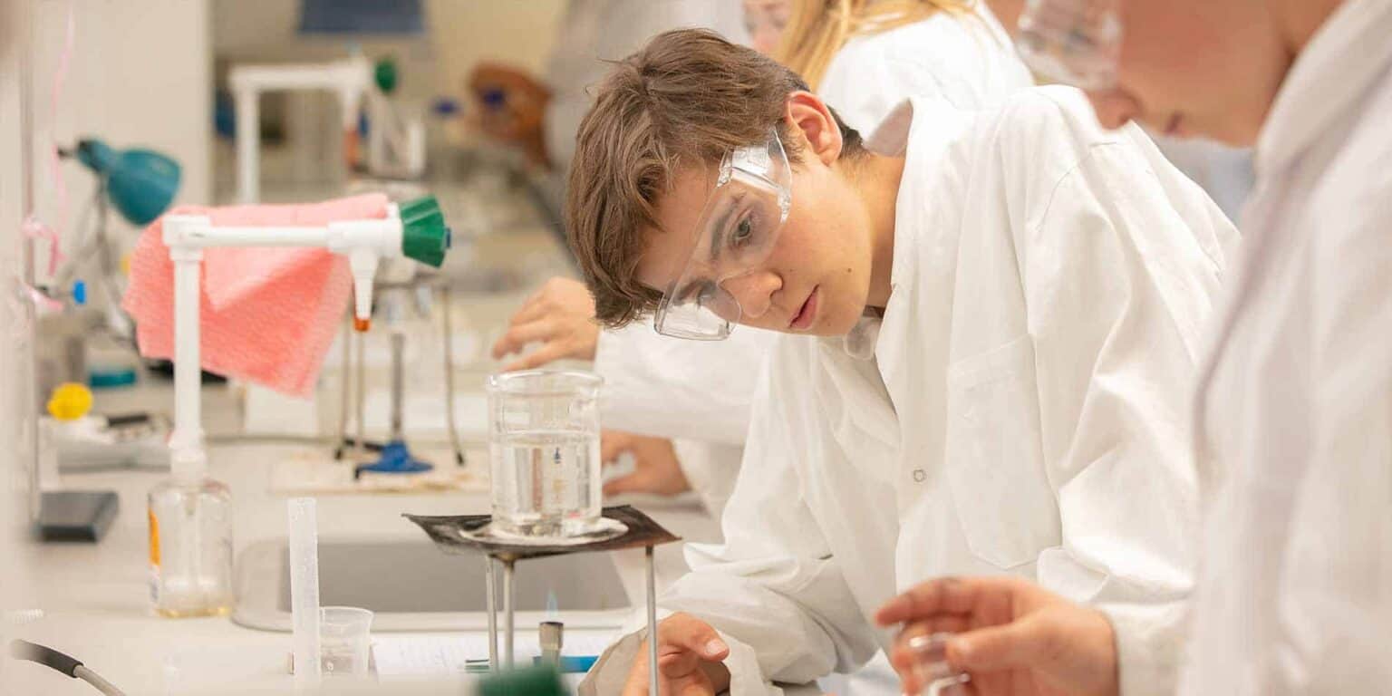 Youth student conducting science experiments in laboratory.