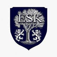Bright blue shield logo with “ESK” and trees, representing World Schools’ educational excellence.