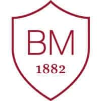 High school crest with BM 1882 emblem, representing World Schools' heritage and academic excellence.