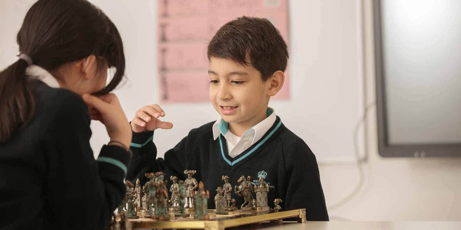 Engaging children playing chess, emphasizing focus, strategic thinking, and educational development in world schools.