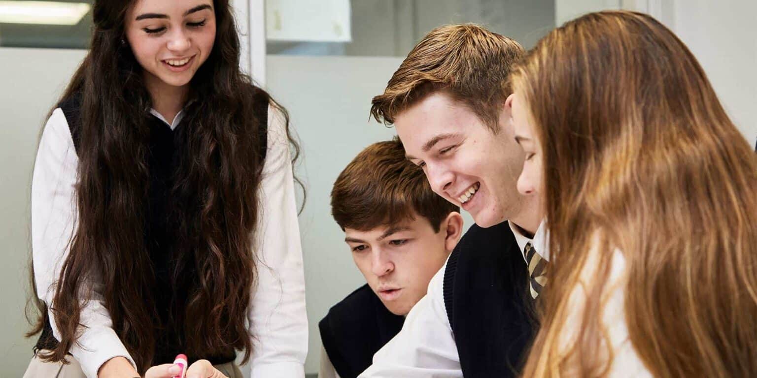 Bright-eyed students collaborating in a diverse classroom environment focused on international education and academic excellence.