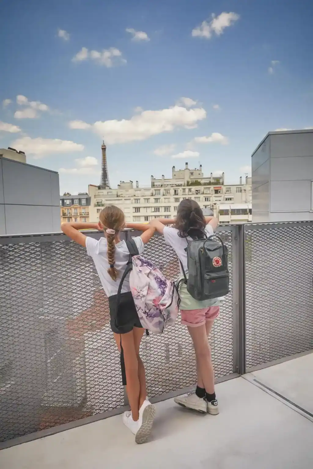 Young students enjoying the Paris skyline from a school rooftop, fostering global perspective and cultural awareness.