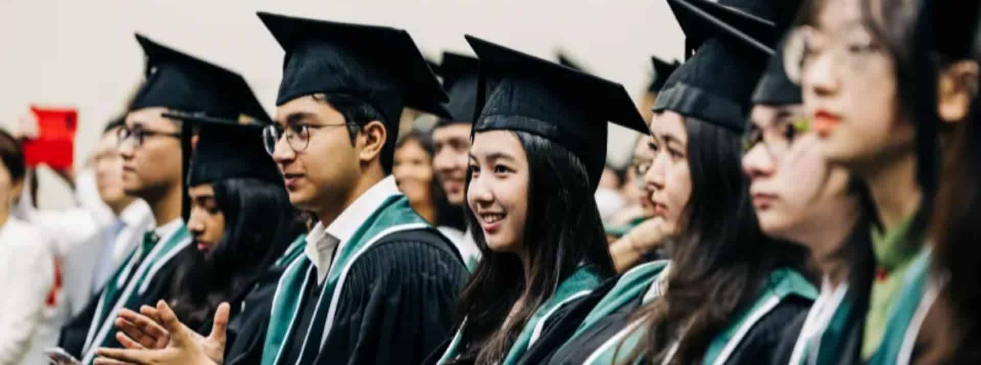 Graduates in caps and gowns at a world school graduation ceremony.