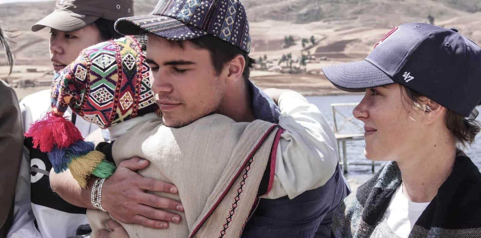 Diverse group of young people from World Schools participating in cultural exchange outdoors.