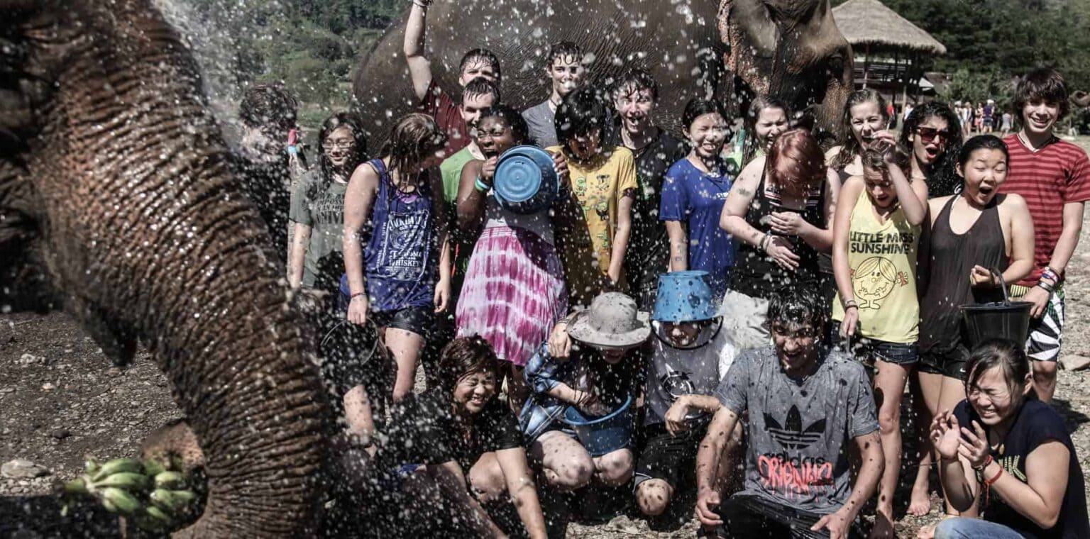 Kids enjoying elephant bath at World Schools outdoor activity.
