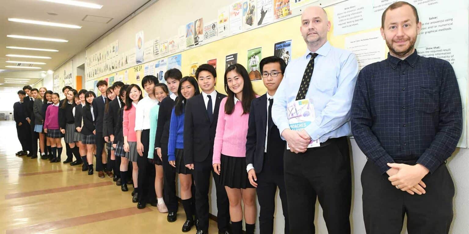 Students and teachers at a modern international school hallway, showcasing diverse educational environment.