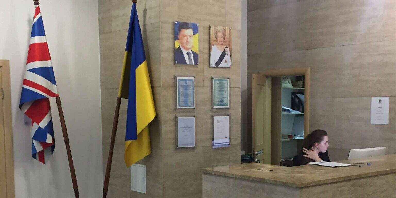 Flags of the UK and Ukraine at a school reception area.