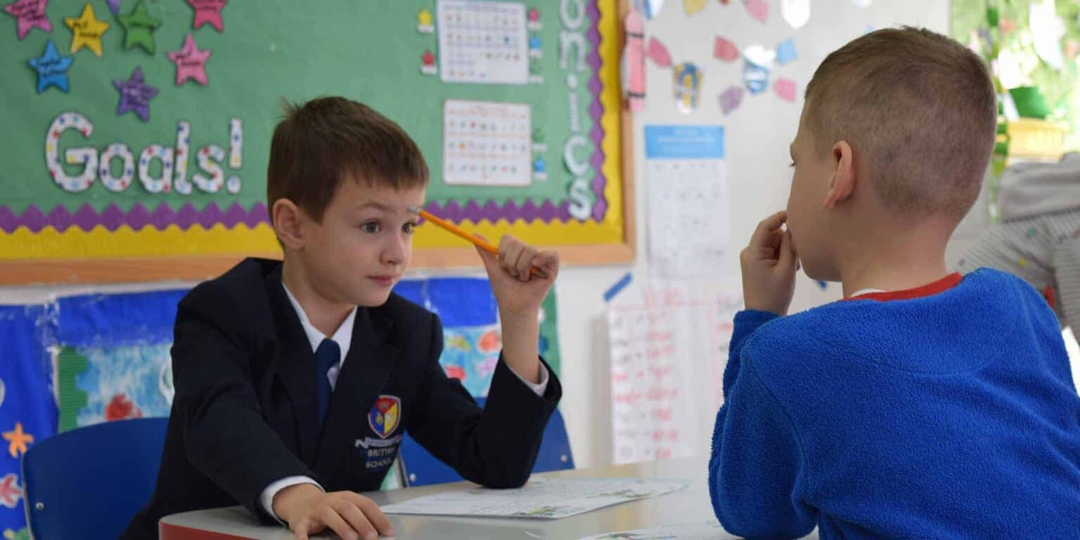 Focused elementary students engaging in classroom discussion for optimal learning outcomes.