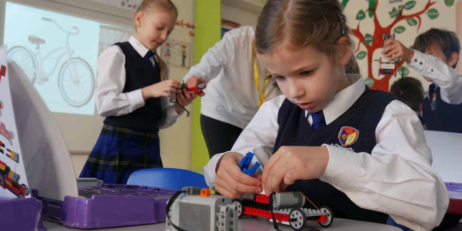 Robotics class at a World Schools international school, students building LEGO robot projects for STEM education.