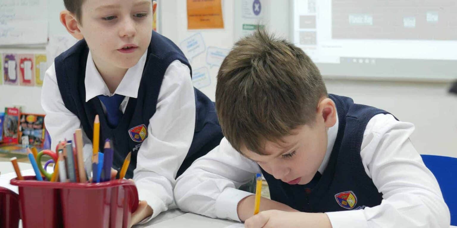 Young students engaged in collaborative classroom learning environment at a world schools institution.