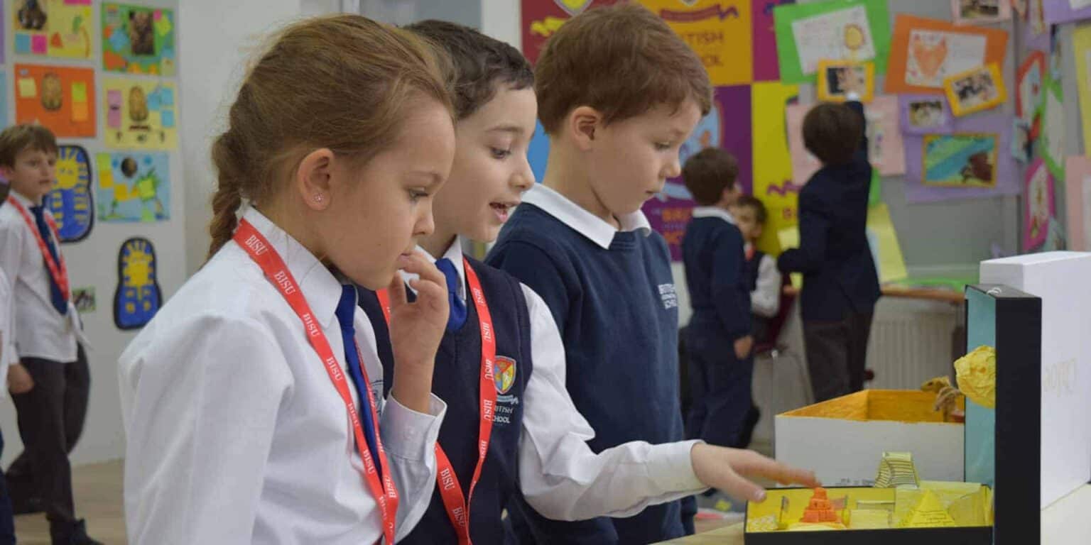 Colorful classroom showcasing students engaging with educational projects and displays for global learning.
