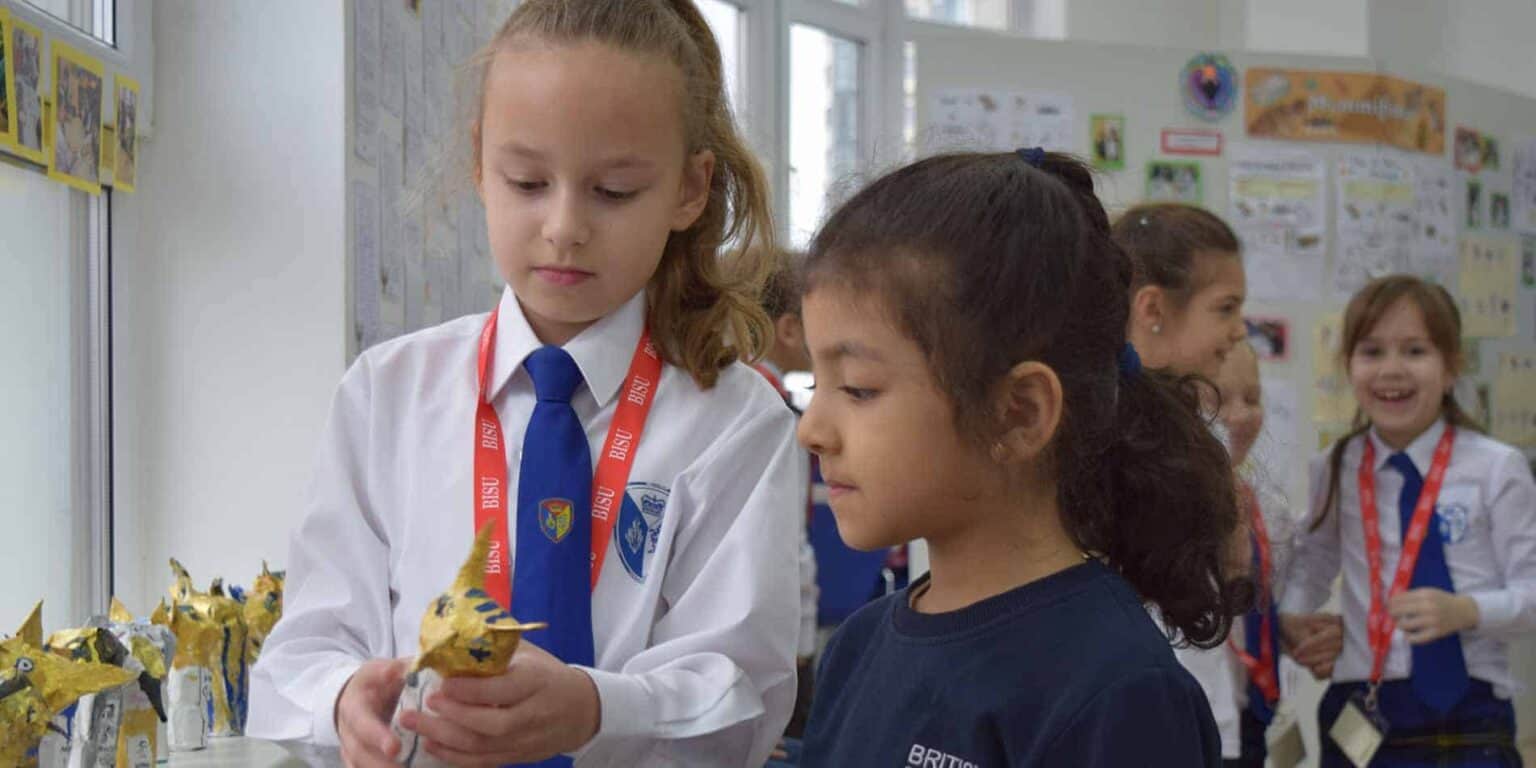 Bright young students at World Schools engaging in a creative educational activity with colorful projects.