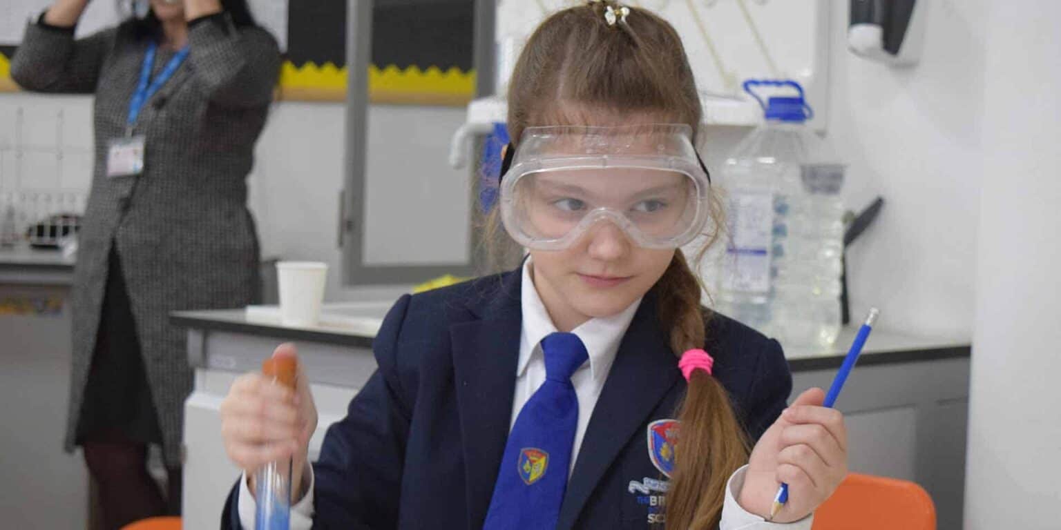 Innovative learning environment at a World School with students engaging in hands-on science experiments.