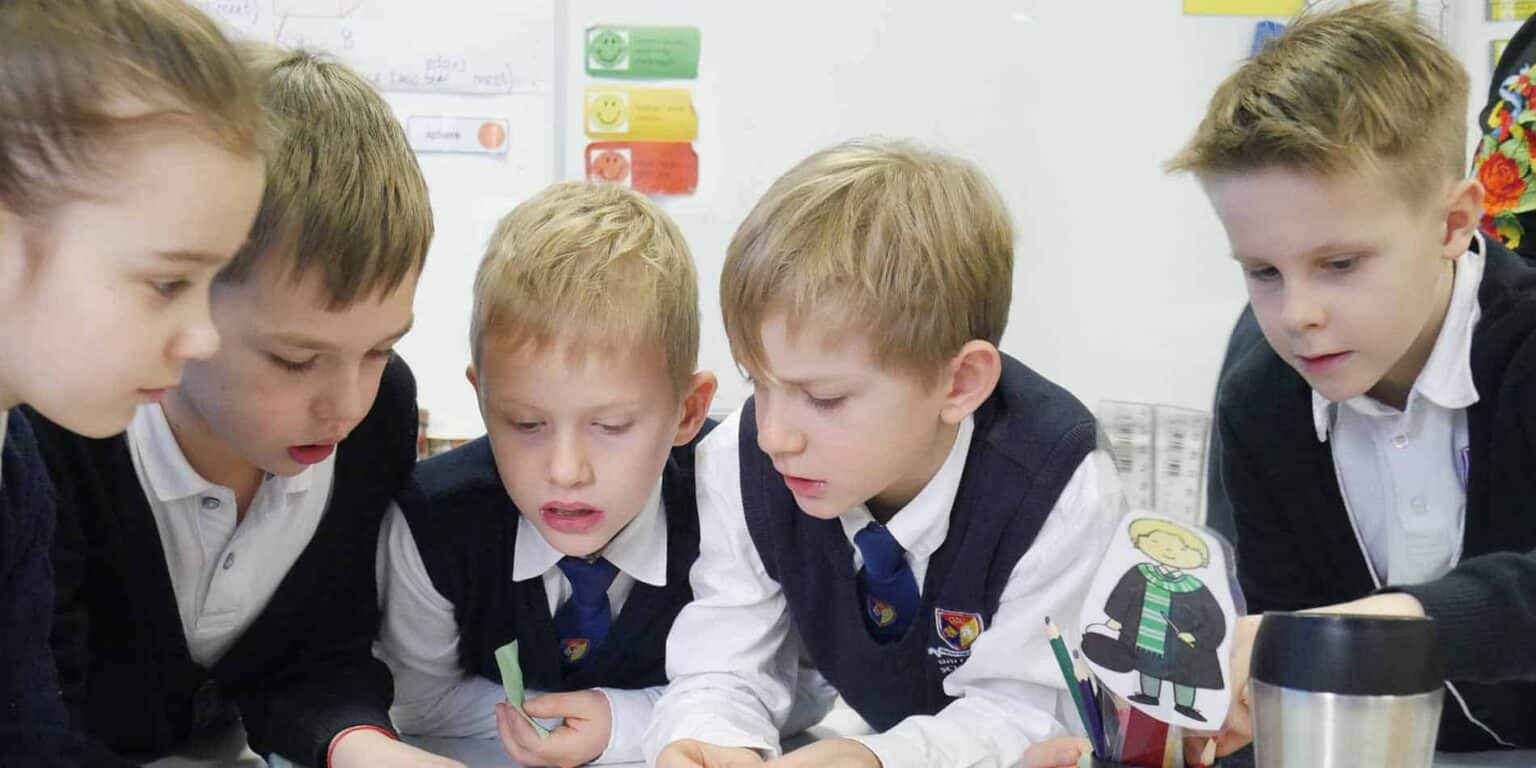 Focused elementary students collaborating on classroom activity, emphasizing innovative teaching methods at World Schools.