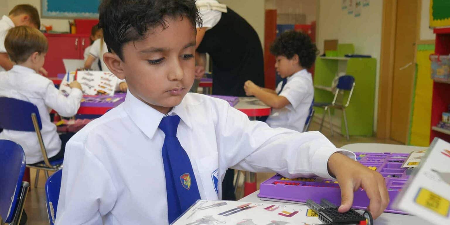 Children studying in a classroom at a World Schools international school, engaging in educational activities.