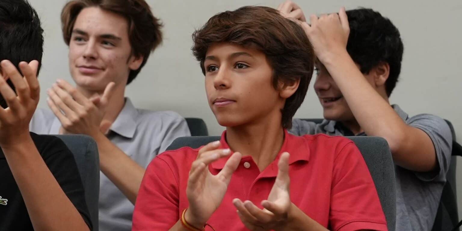 Bright diverse students engaging in classroom discussion at World Schools.